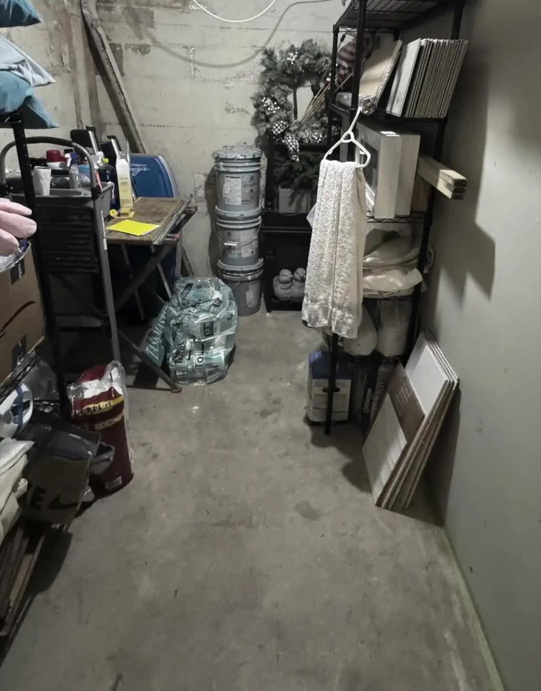 Garage storage area before a DeclutterMeNow organizing project.